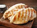 Petto di pollo grigliato, perfetti secondi di carne da preparare in anticipo. Un contorno di sale completa l'immagine.
