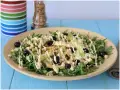 Deliziosa insalata di pollo con rucola, sedano, olive nere e capperi, condita con una cremosa salsa.