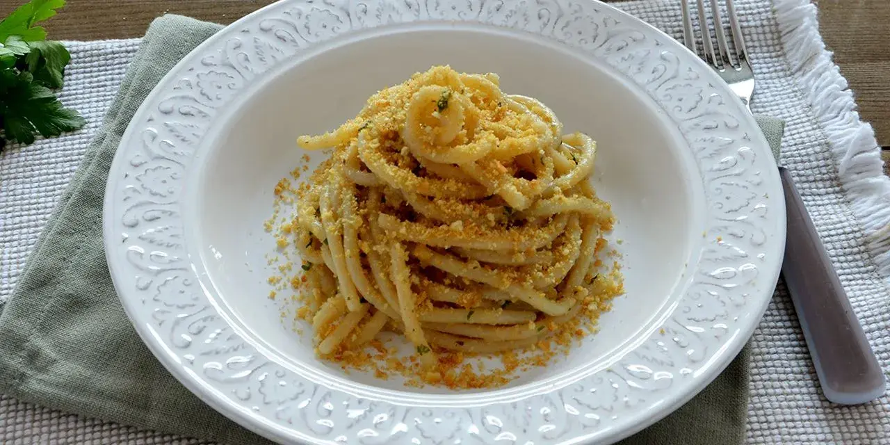 Pasta con pangrattato e acciughe alla siciliana, un piatto semplice ma ricco di sapore, pronto per essere gustato.