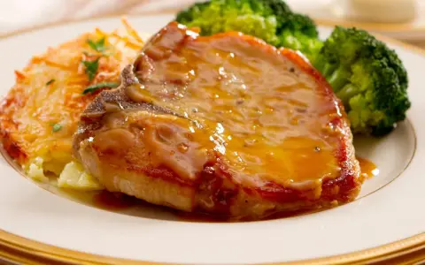 Succulento braciola di maiale con salsa, patate gratinate e broccoli. Secondi di carne per fare bella figura, un piatto che conquista.