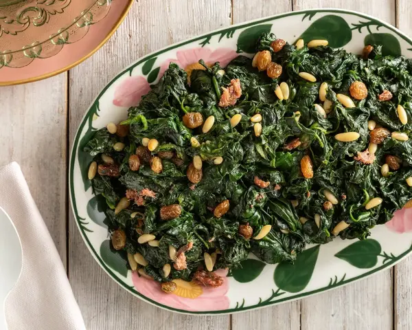 Spinaci saltati con pinoli e uvetta, un modo gustoso per imparare come cucinare gli spinaci.
